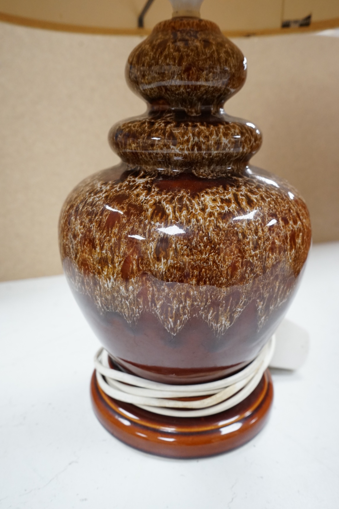 A mid century modern brown glazed ceramic table lamp and brown braided shade, 84cm including shade